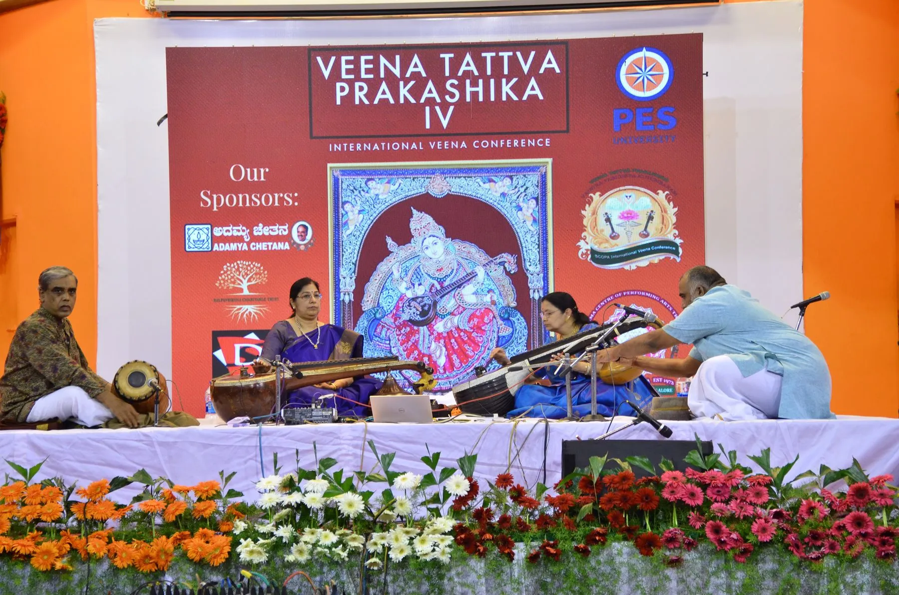 Wide stage with VTP IV banner and flowers