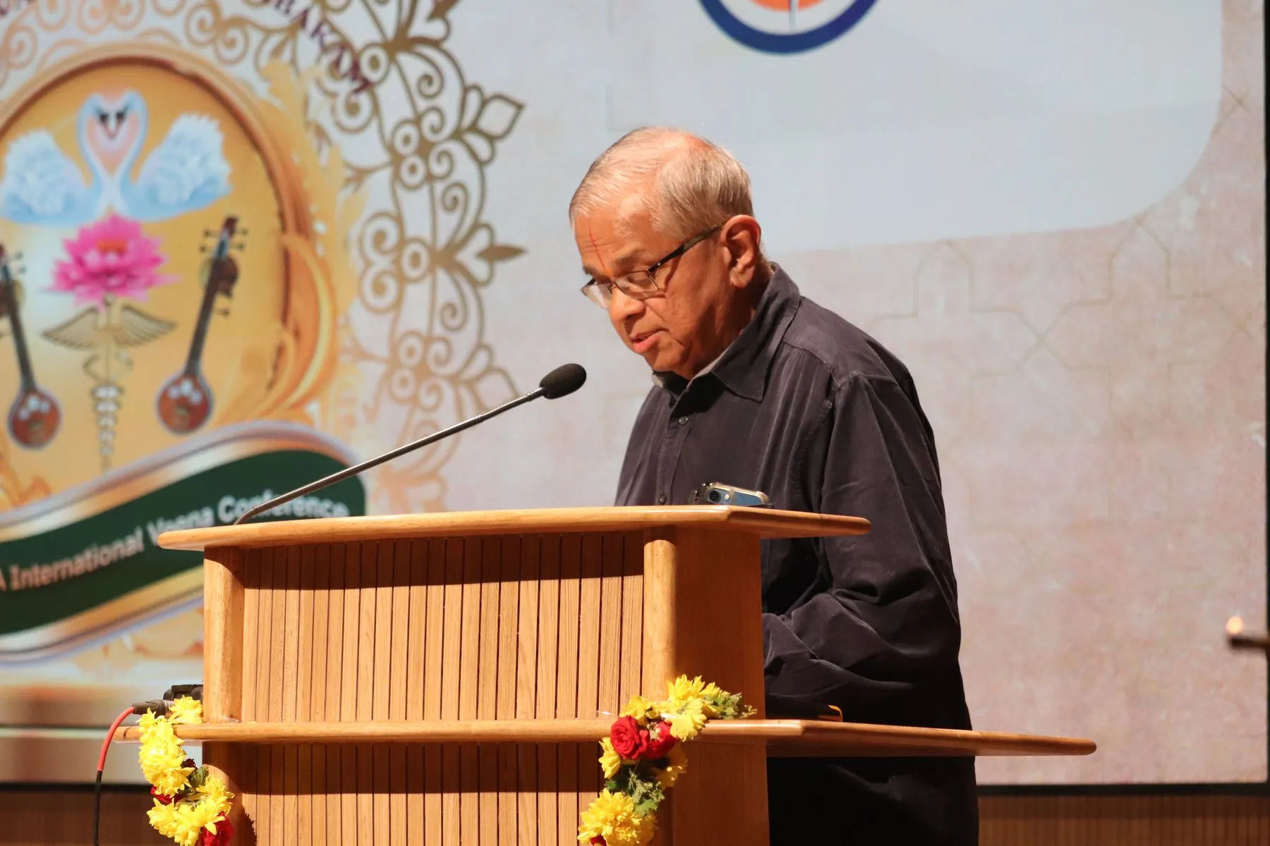 Speaker at podium with logo
