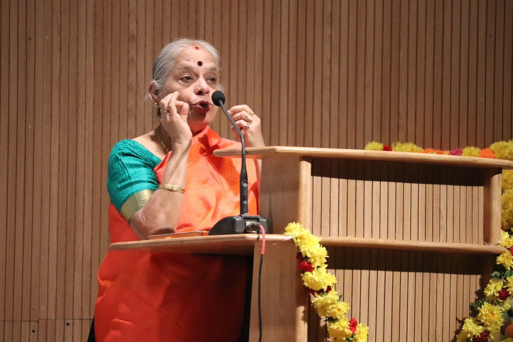 Senior woman speaking at podium
