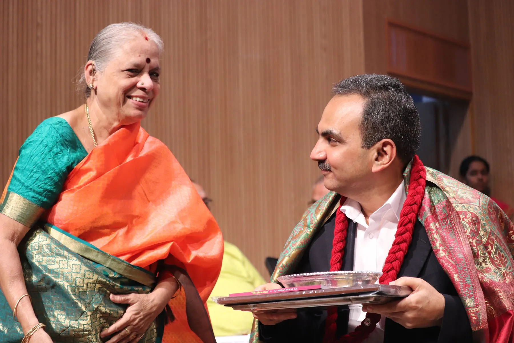 Senior guest laughing while felicitating