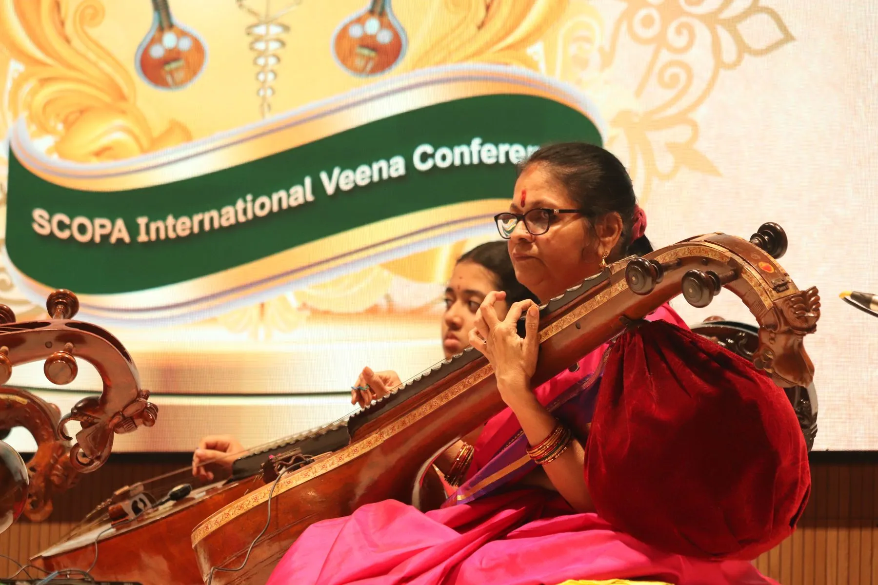 Young vainika with SCOPA banner