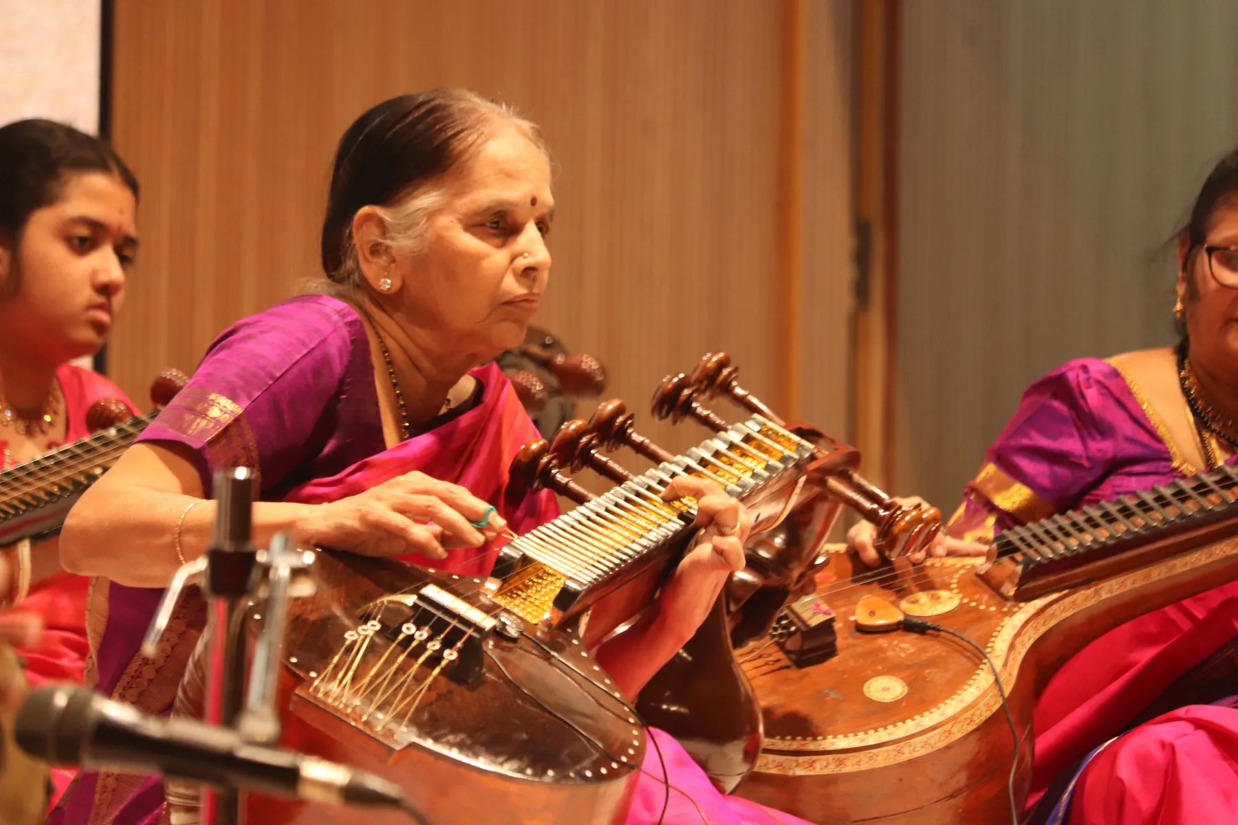 Senior vainika leading student ensemble, close