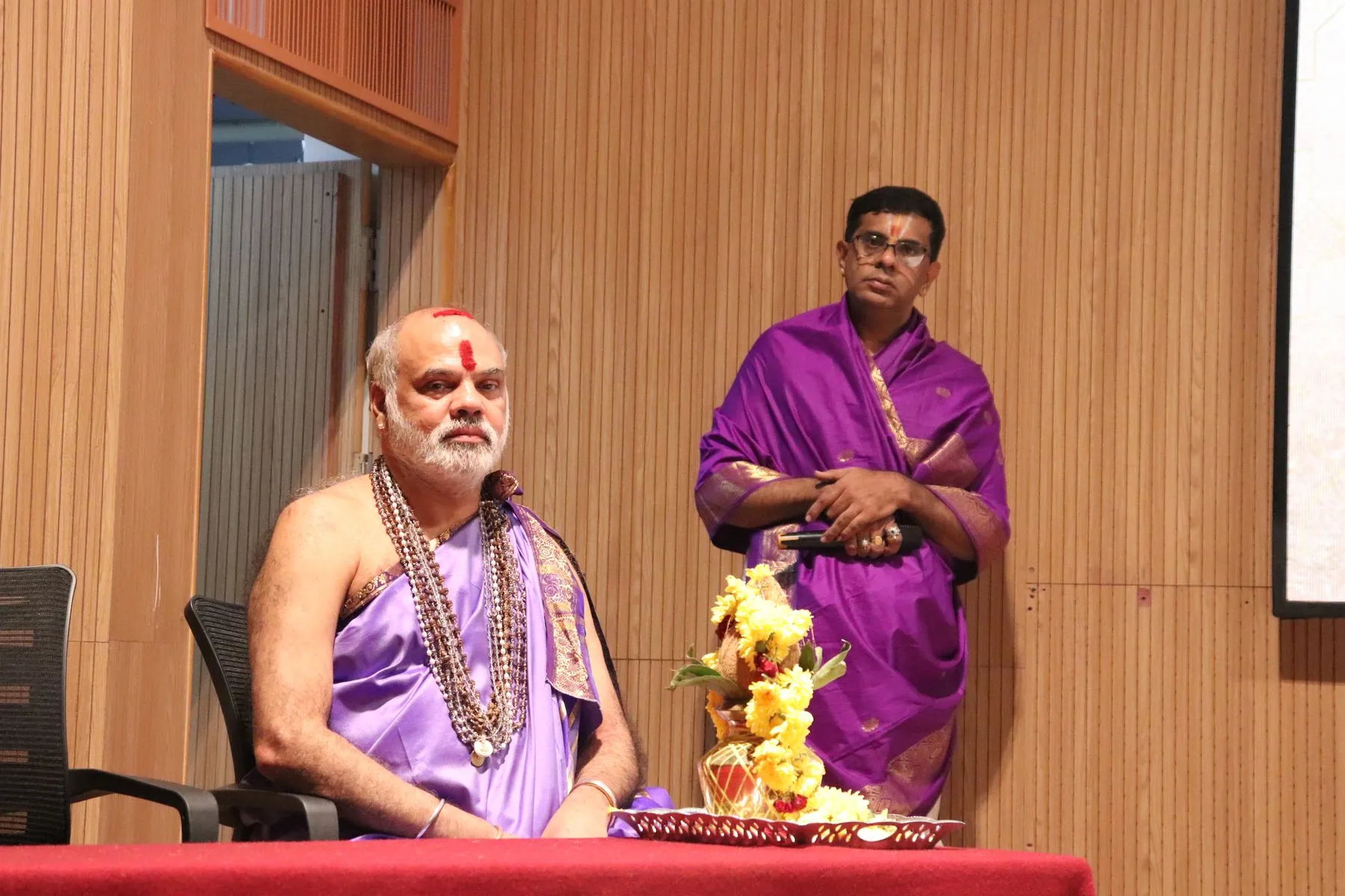Two seers seated with shrine