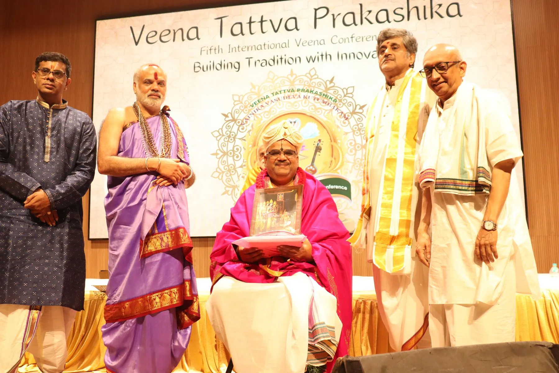 Group on stage with VTP V backdrop
