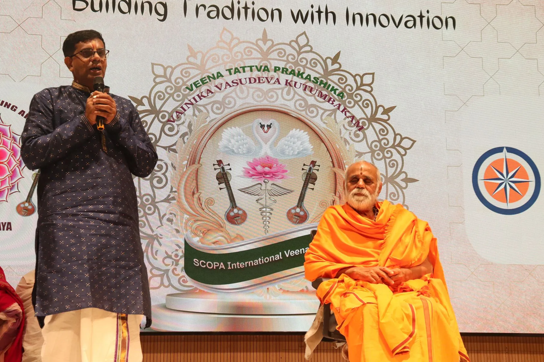Compere with seer, logo backdrop