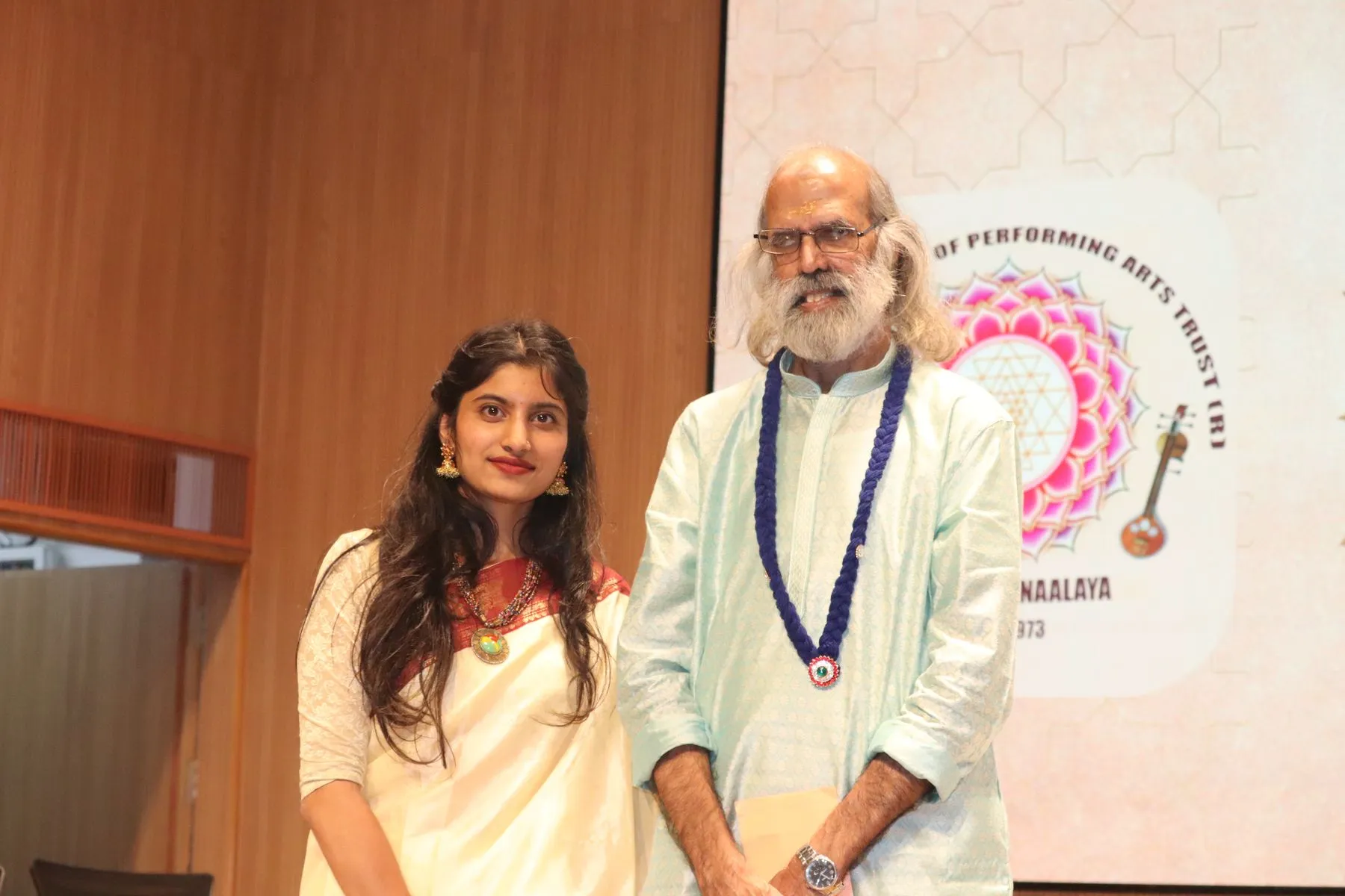 Elder vainika with young volunteer